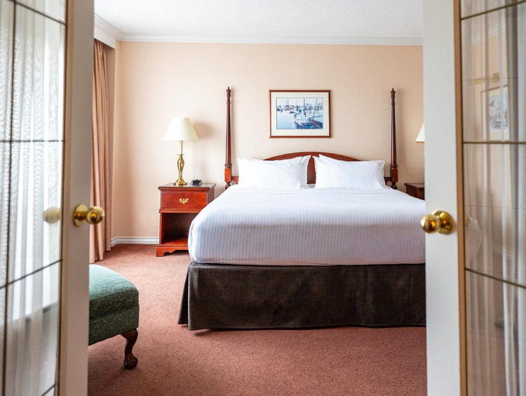 A king bed between open French doors