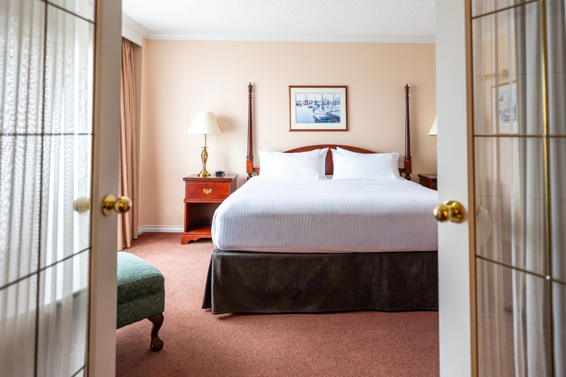 A king bed between open French doors