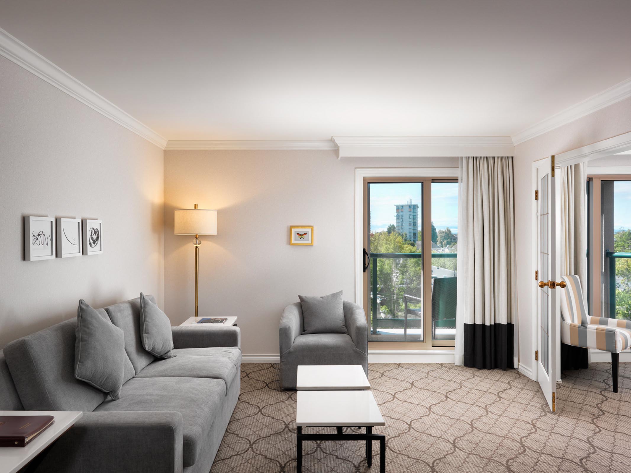 A living room with a grey sofa and armchair