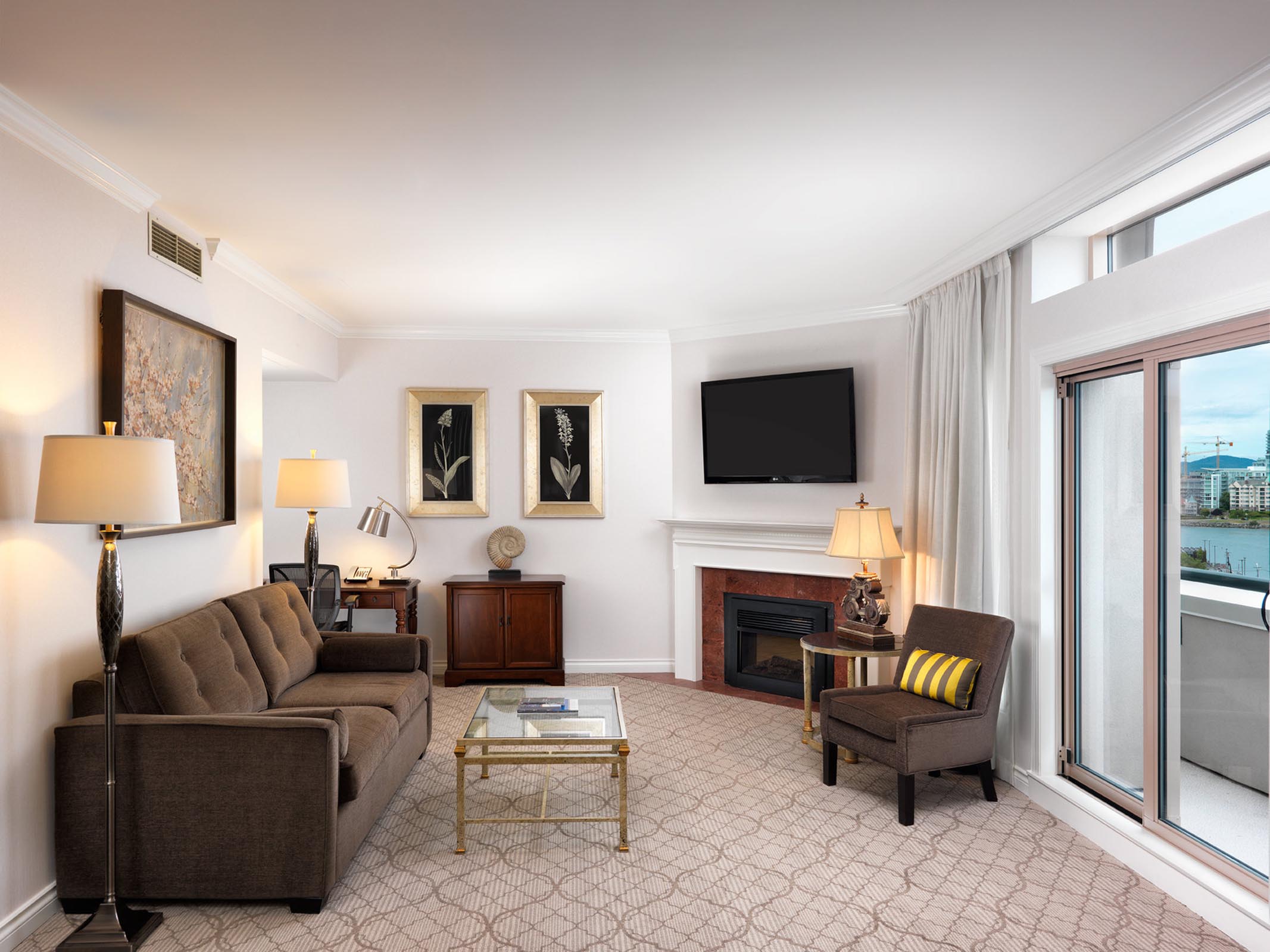 Living room with fireplace, couch, chair, and TV