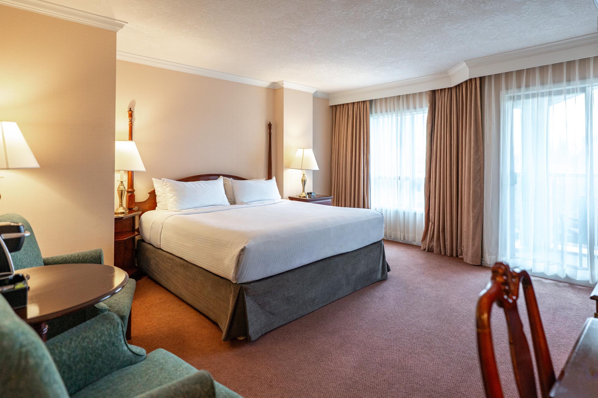 King bed beside a large window