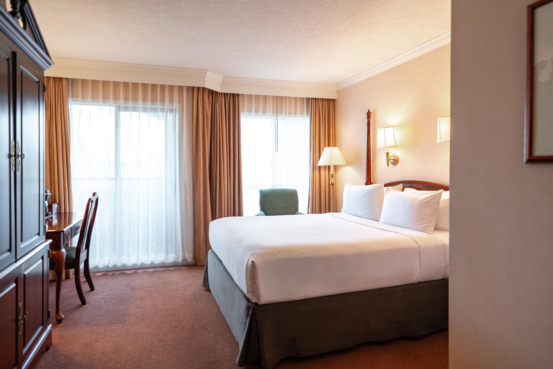 King bed beside large windows