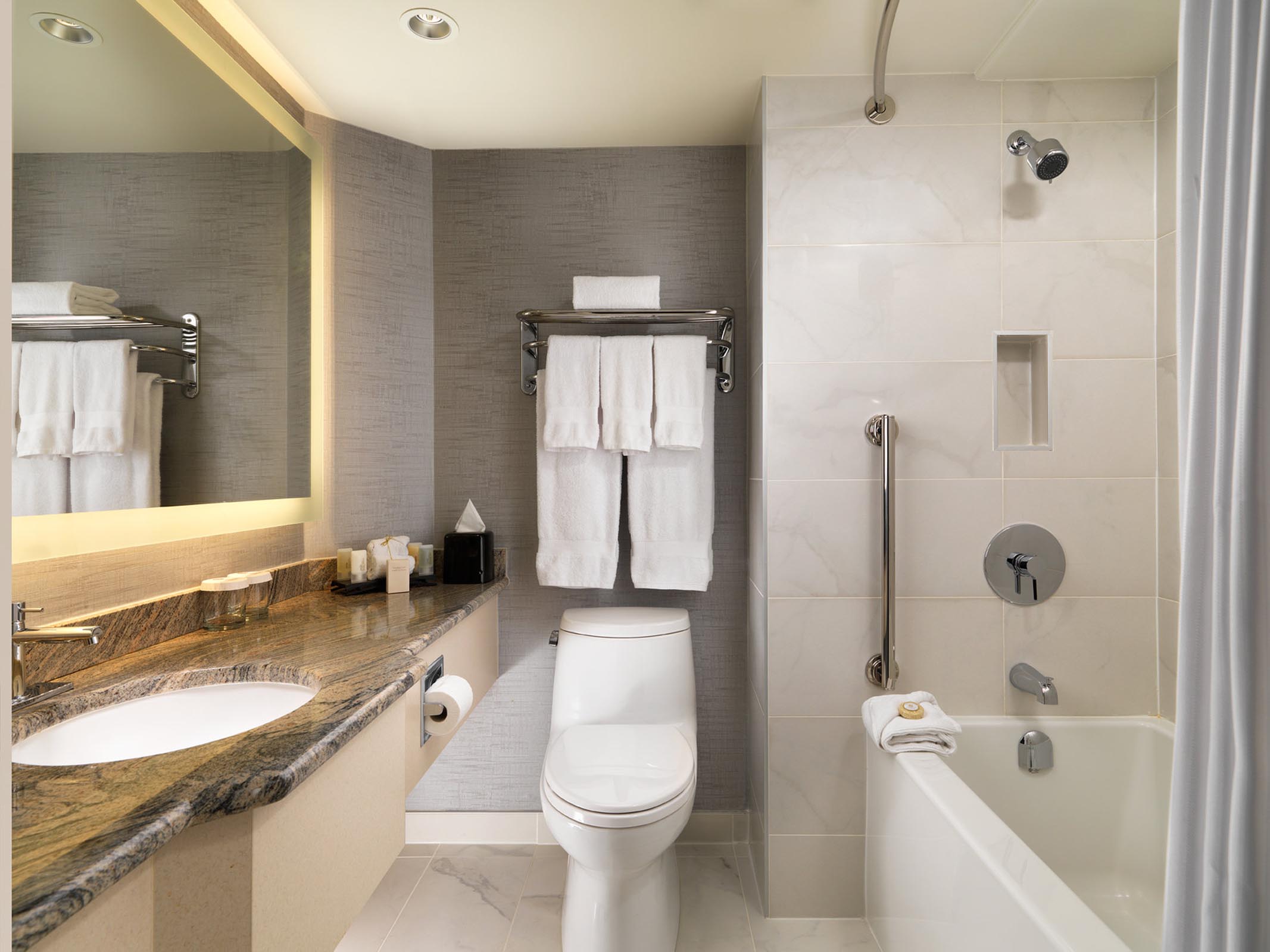 Bathtub, toilet, countertop, and towel rack